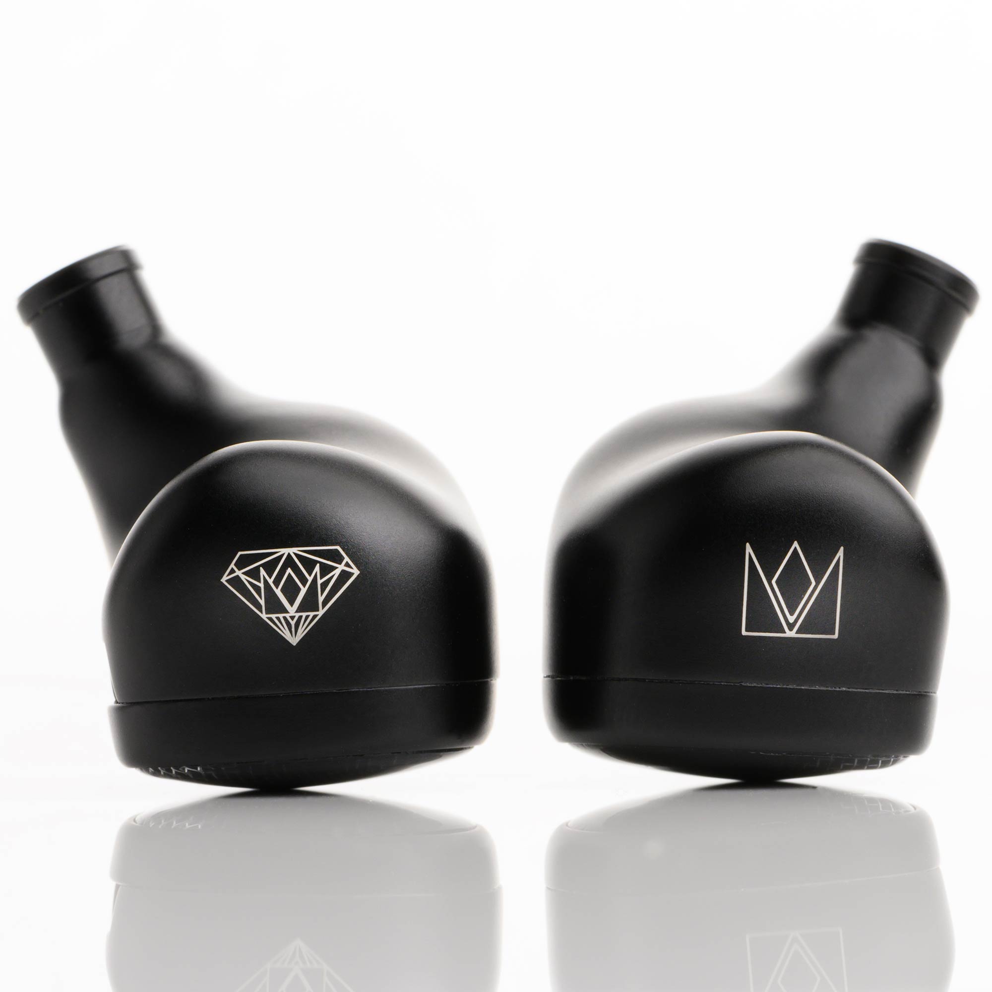Close-up of black Noble Audio Onyx Universal Fit In-Ear Monitors resting on reflective surface with logos visible