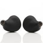Close-up of black Noble Audio Viking Ragnar Universal-Fit IEM earpieces displaying textured matte finish on white background