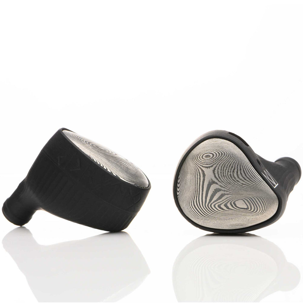 Close-up of Noble Audio Viking Ragnar Universal-Fit IEM with patterned faceplates on white reflective surface