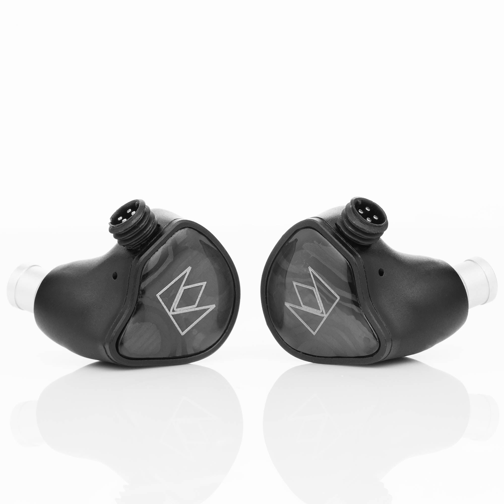 Pair of black Noble Audio XM-1 IEM with xMEMS Driver earphones showing connector pins and transparent logo plates on white background