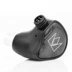 Close-up of the black Noble Audio XM-1 IEM with xMEMS Driver showing the earbud shell and connector pins on a white background