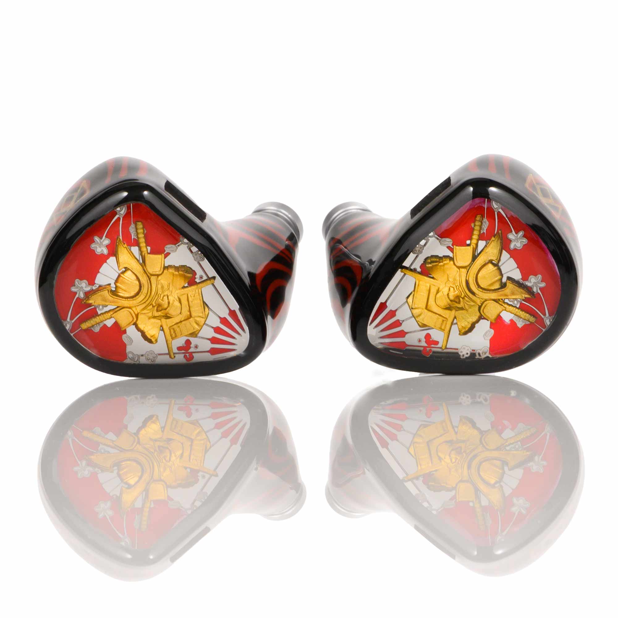 Pair of Noble Audio Shogun IEMs with red, gold, and black samurai-themed design on reflective surface
