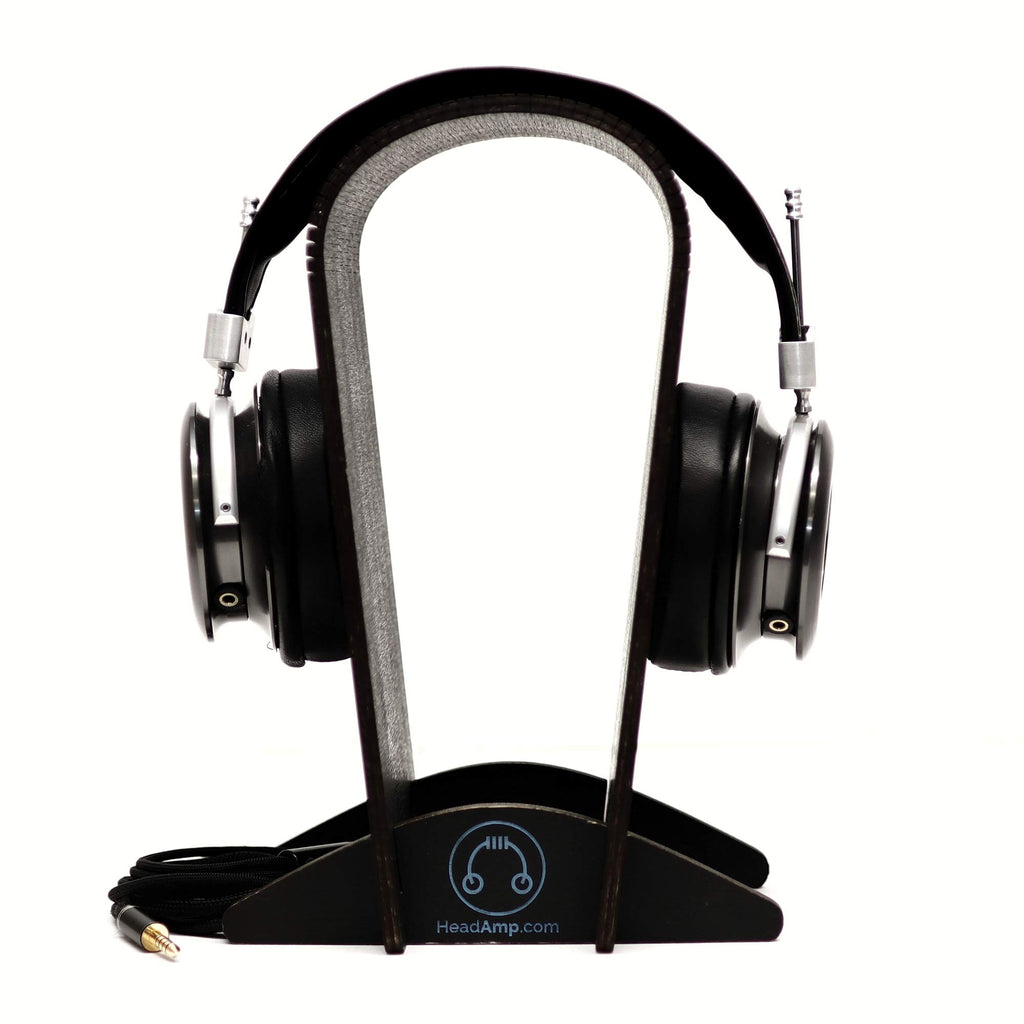 Spirit Torino Radiante Closed-Back (Pre-Owned) headphones displayed on a wooden headphone stand with cable attached