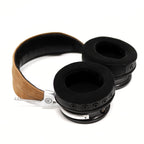 Spirit Torino Titano semi-closed back headphones with black ear pads and tan suede headband on white background