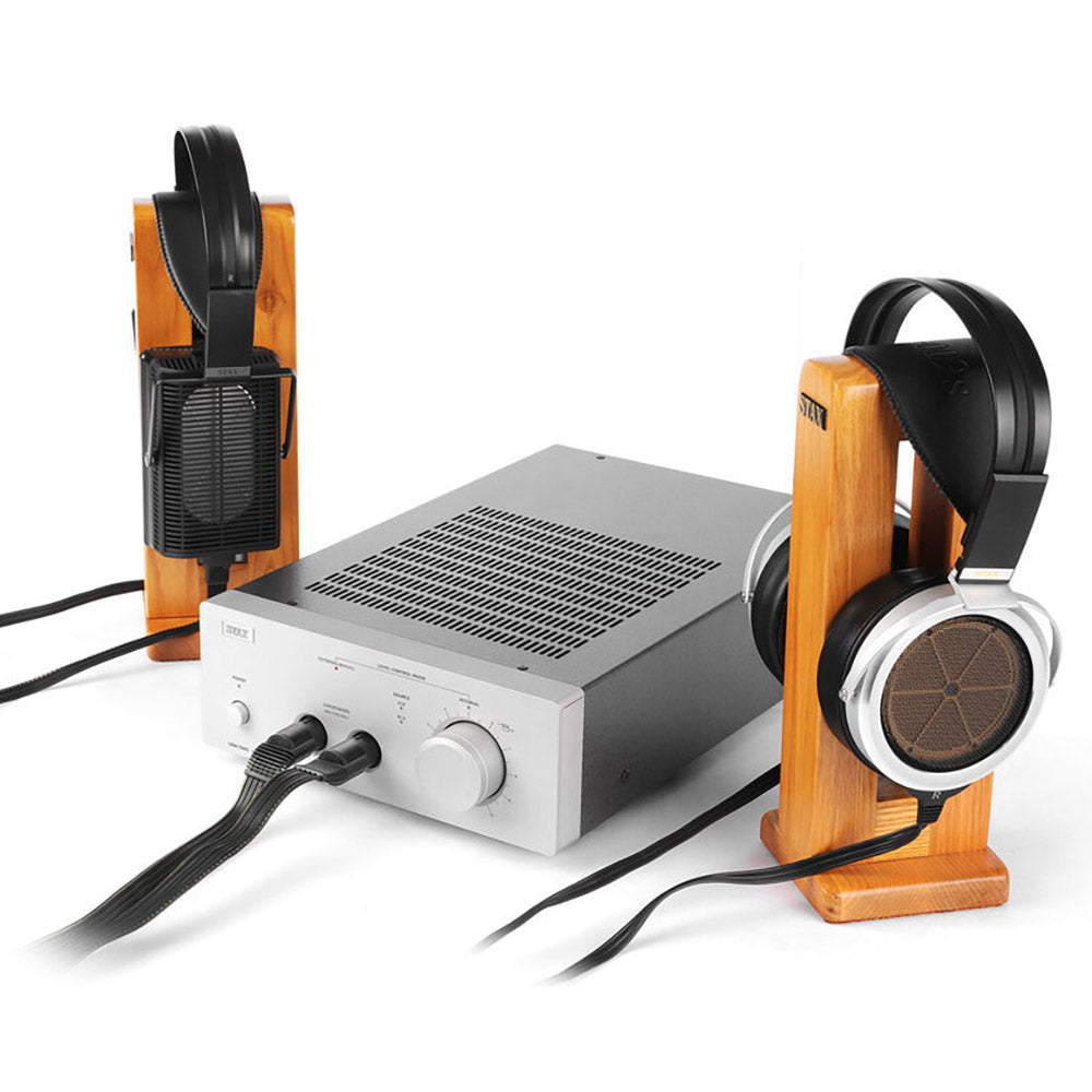 STAX SRM-700S Electrostatic Headphone Amplifier connected to electrostatic headphones on wooden stands against white background