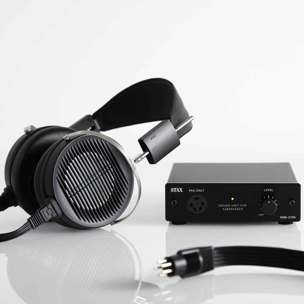 STAX SRS-X1000 Electrostatic Earspeaker System with black earcups and SRM-270S driver unit on reflective surface