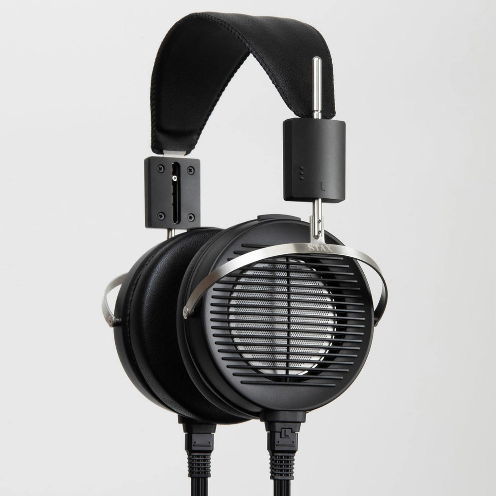 STAX SR-X1 Electrostatic Earspeaker with black ear cups and metal headband supports on a light background
