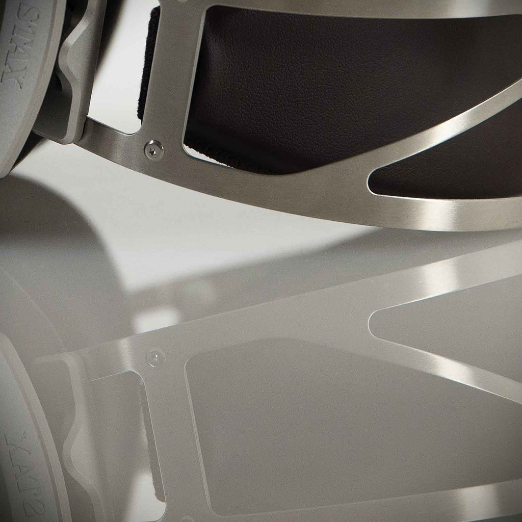 Close-up of STAX SR-007S Electrostatic Headphones metal headband and reflection on a light surface