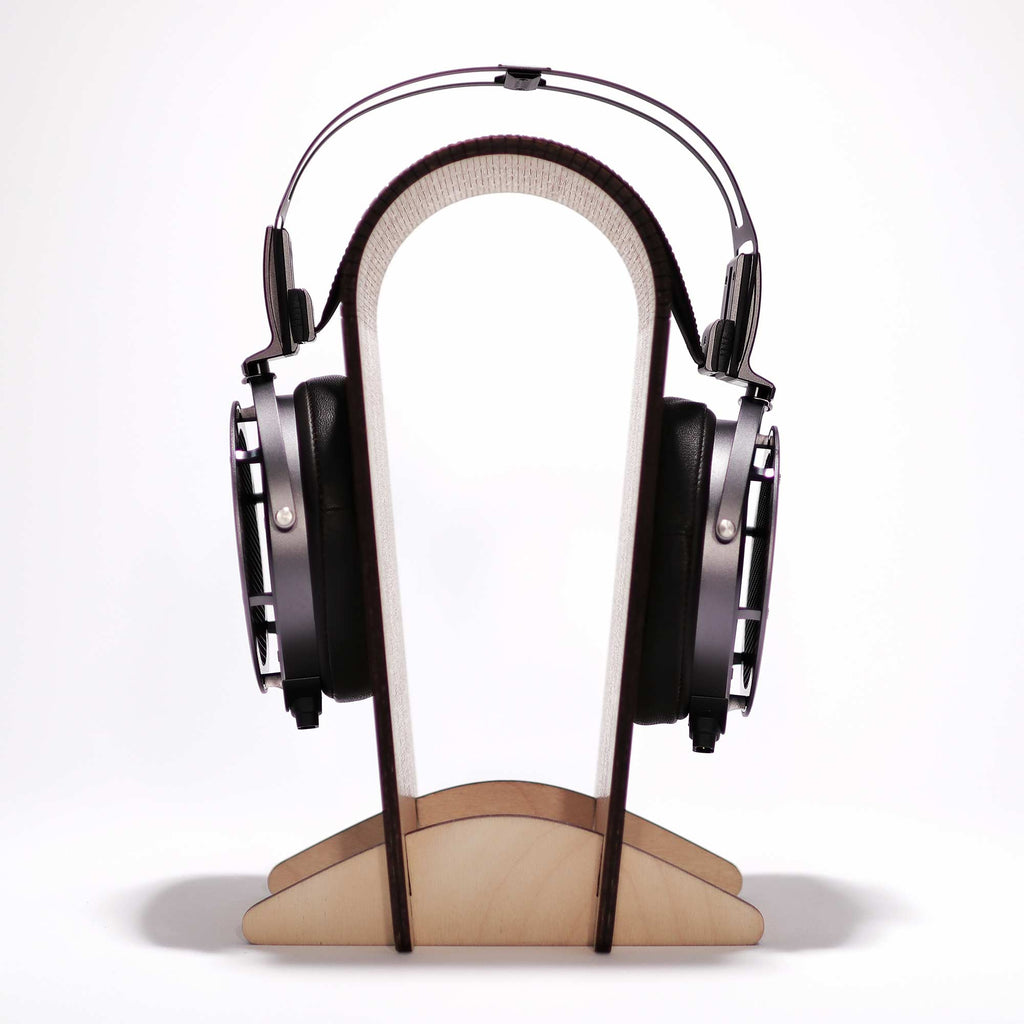 STAX SR-X9000 electrostatic headphones resting on a minimalist wooden headphone stand against a white background