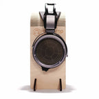 Front view of STAX SR-X9000 electrostatic open back headphones displayed on a wooden headphone stand
