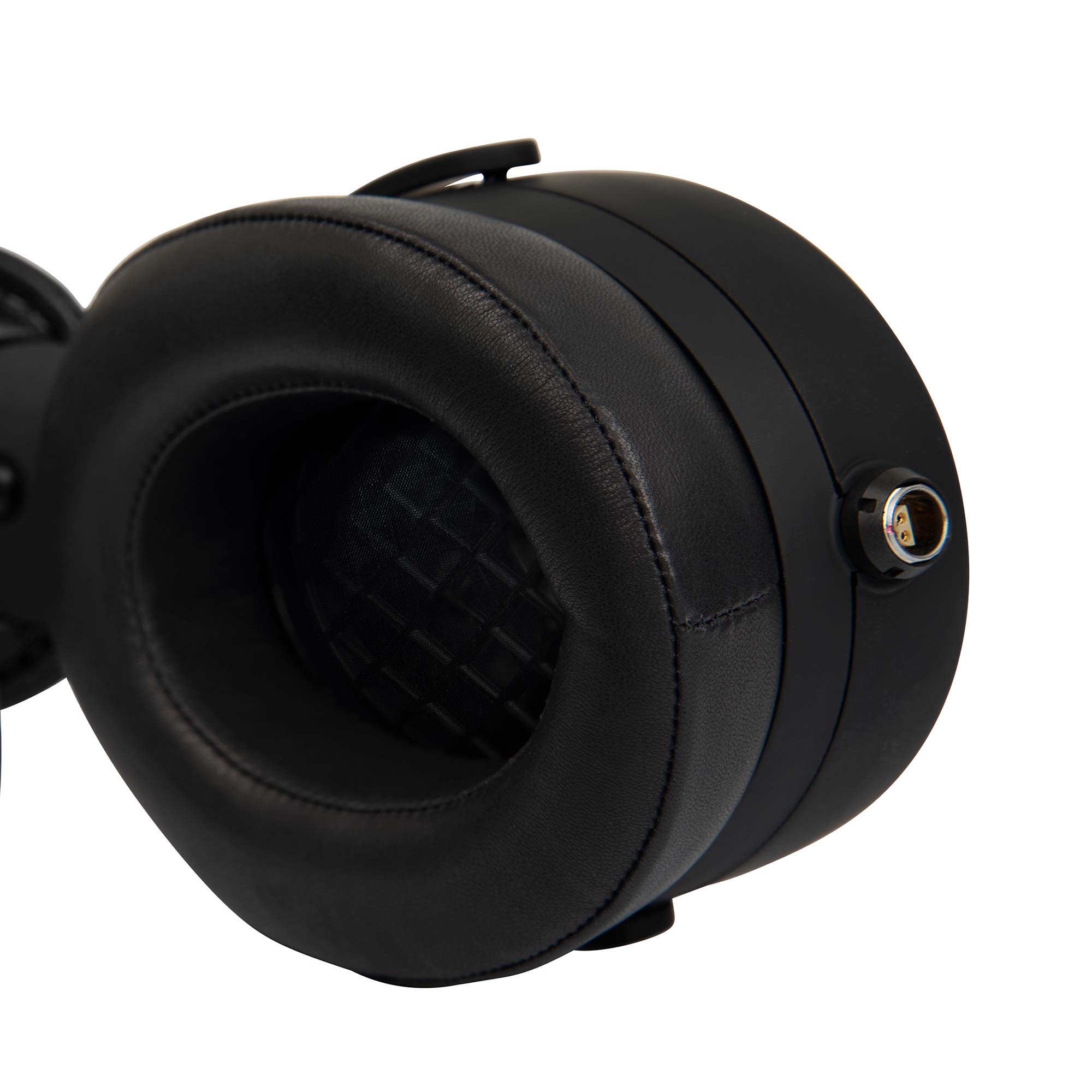 Close-up of the Warwick Acoustics BRAVURA Electrostatic Earspeaker System earcup showing black leather padding and connector port.