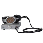 Warwick Acoustics BRAVURA Electrostatic Earspeaker System resting on a silver amplifier with black cables connected on white background