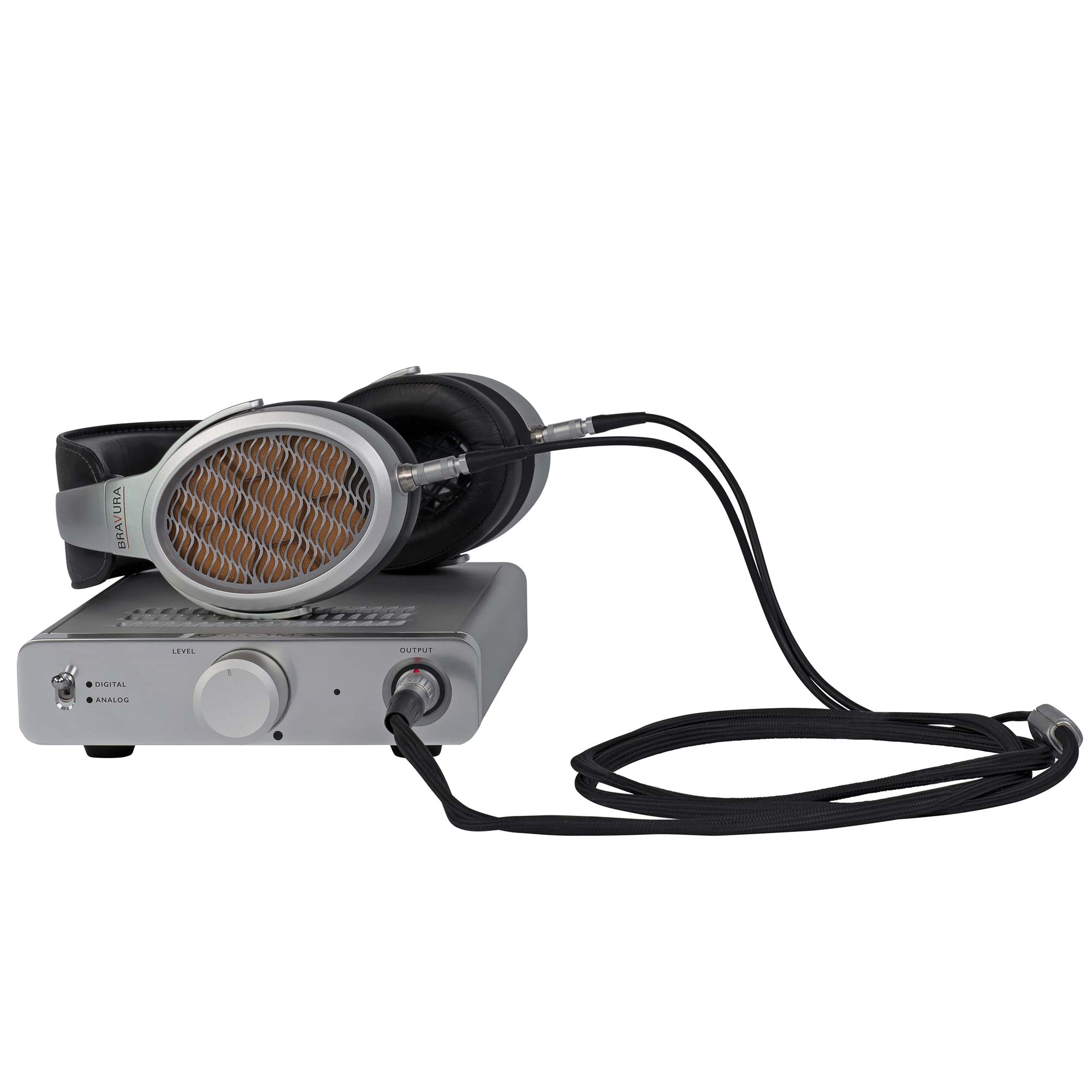 Warwick Acoustics BRAVURA Electrostatic Earspeaker System resting on a silver amplifier with black cables connected on white background