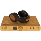 Warwick Acoustics APERIO Electrostatic Earspeaker System with black and gold headphones on gold amplifier unit