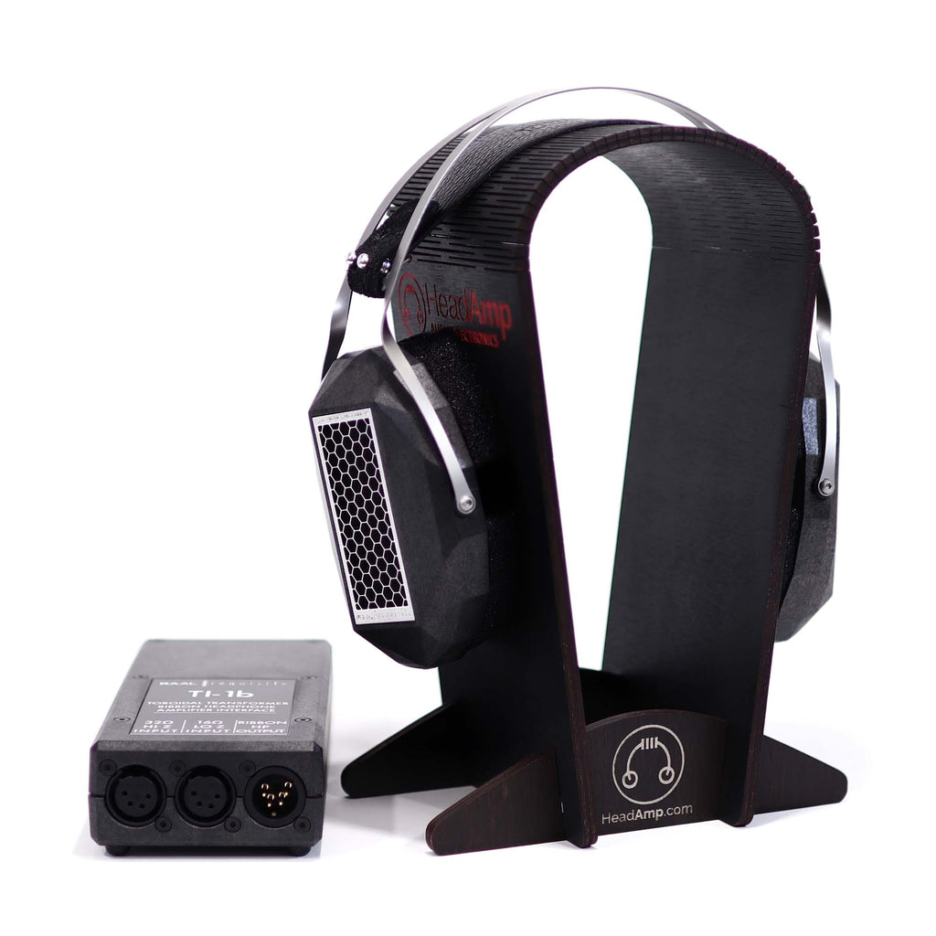 RAAL-requisite CA-1a Circum-Aural Ribbon Headphone on black wood stand with amplifier unit on white background