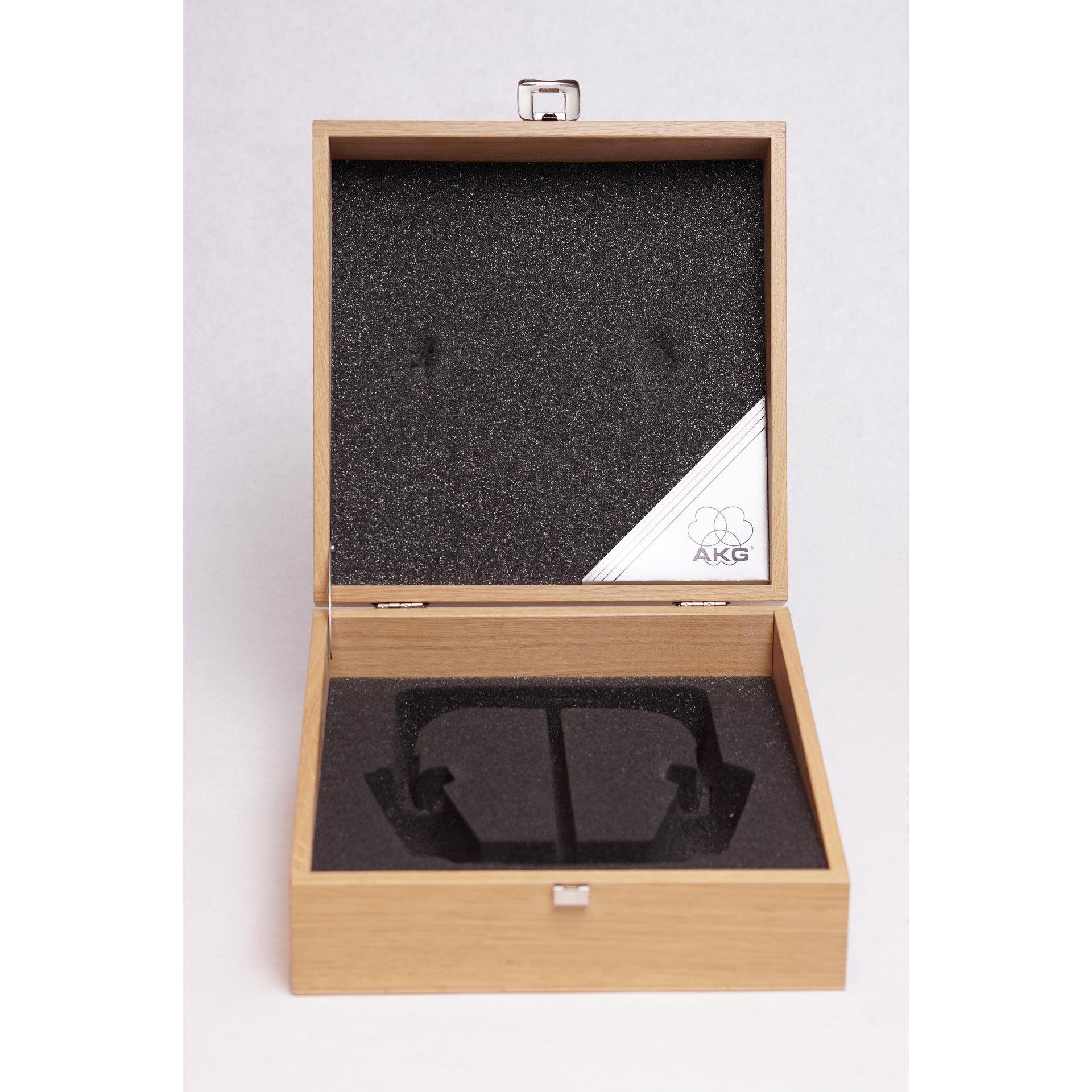 Open wooden box with custom foam insert and AKG logo, designed to hold the AKG K1000 headphones securely