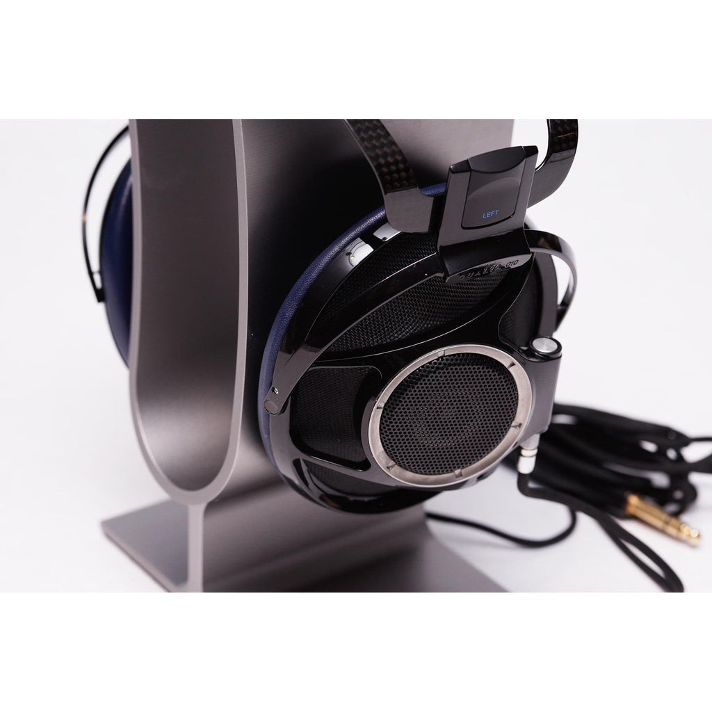 Sony Qualia 010 Reference Headphone with black and blue ear cups on a silver headphone stand with attached cable