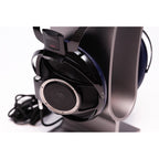 Close-up of Sony Qualia 010 Reference Headphone with black and blue ear cups resting on a silver headphone stand