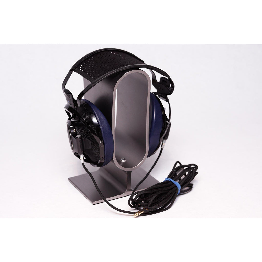 Sony Qualia 010 Reference Headphone with rare blue ear pads displayed on a silver headphone stand with coiled cable