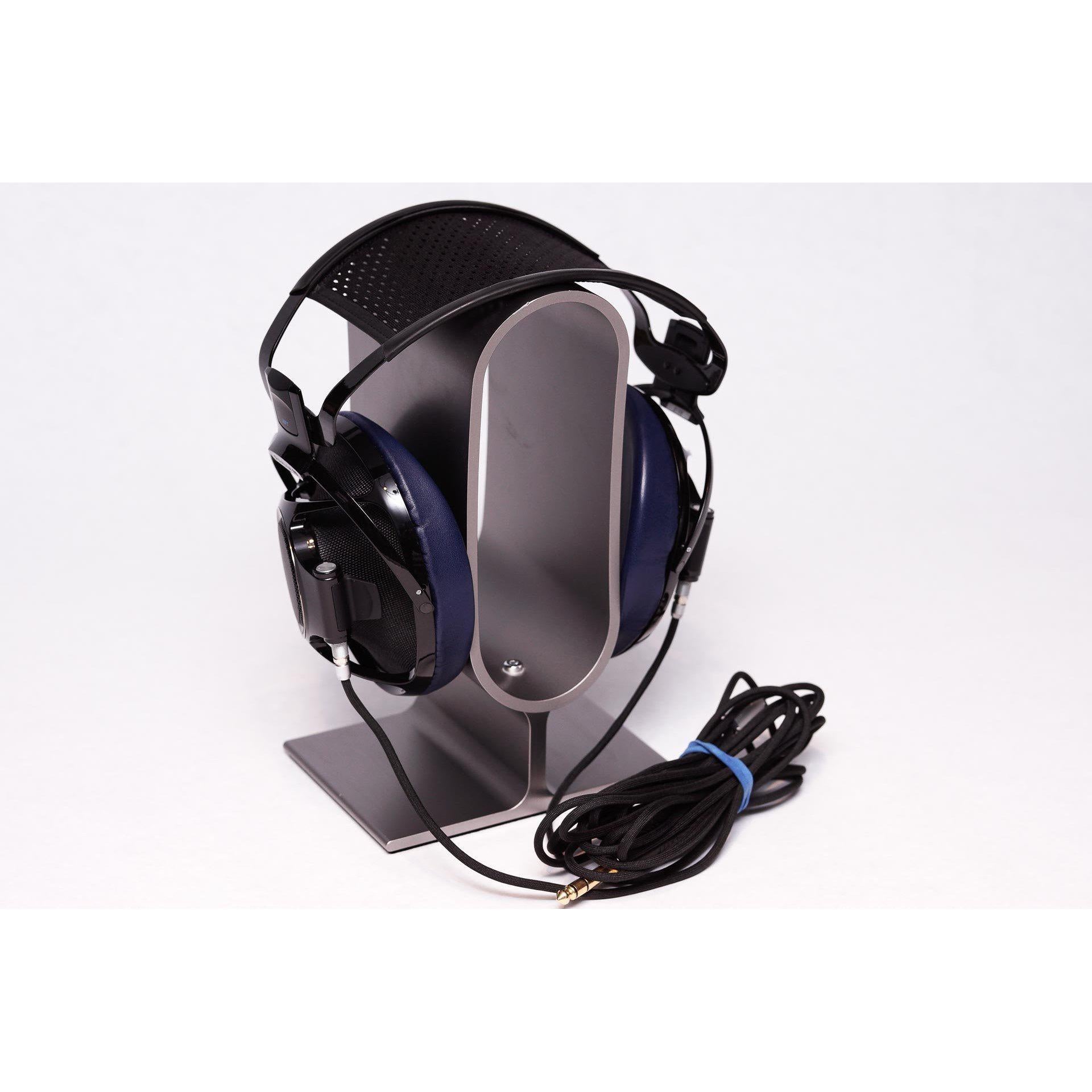 Sony Qualia 010 Reference Headphone with rare blue ear pads displayed on a silver headphone stand with coiled cable