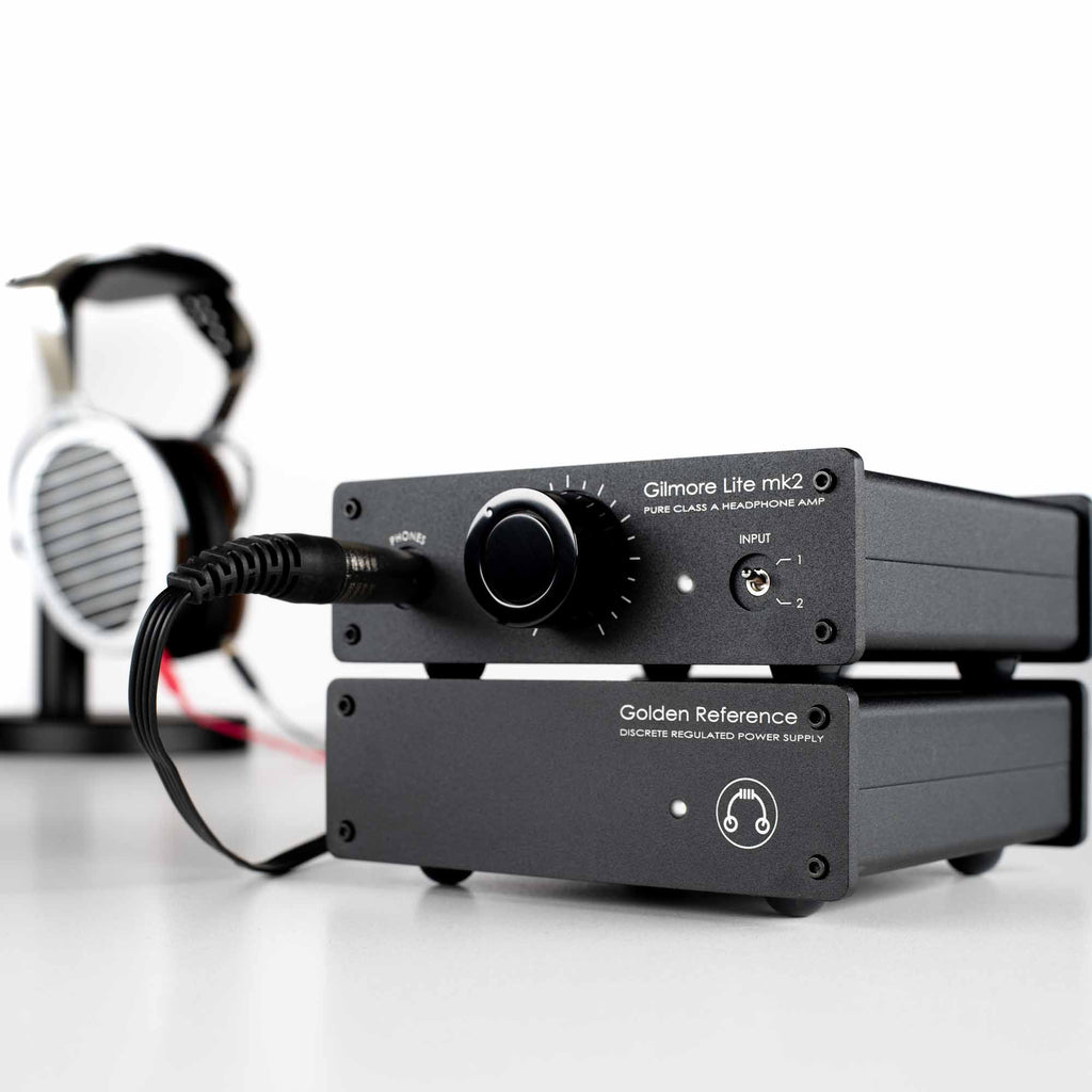 HeadAmp Gilmore Lite Mk2 Class-A Headphone Amplifier with Golden Reference power supply and connected headphones on white surface