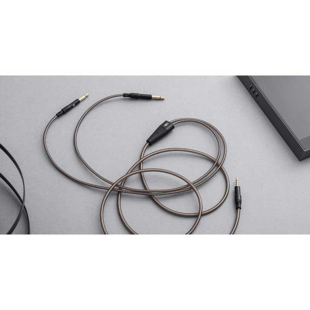 Meze 99 Series OFC Balanced Upgrade Headphone Cable with black connectors and braided silver-plated wire on gray surface