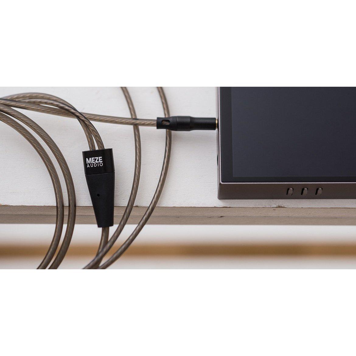 Meze 99 Series OFC Balanced Upgrade Headphone Cable connected to device with visible Meze Audio logo on black connector