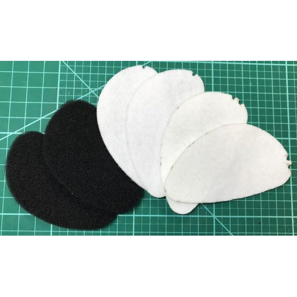 Dan Clark Audio AEON Tuning Kit showing black foam and white felt sound filters on a green cutting mat