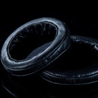 Dan Clark Audio VOCE Electrostatic Headphone Replacement Ear Pads in black leather texture on a dark surface close-up