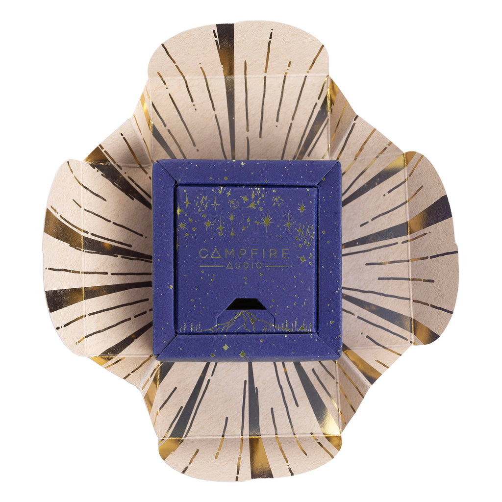 Campfire Orbit | True Wireless Earphones packaging box with starry design placed on unfolded decorative paper background