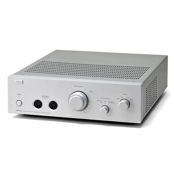 Silver electrostatic headphone amplifier by STAX, featuring ventilation grids and control knobs.

