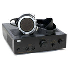STAX SRM-T8000 electrostatic headphone amplifier with headphones resting on top, black design with control knobs