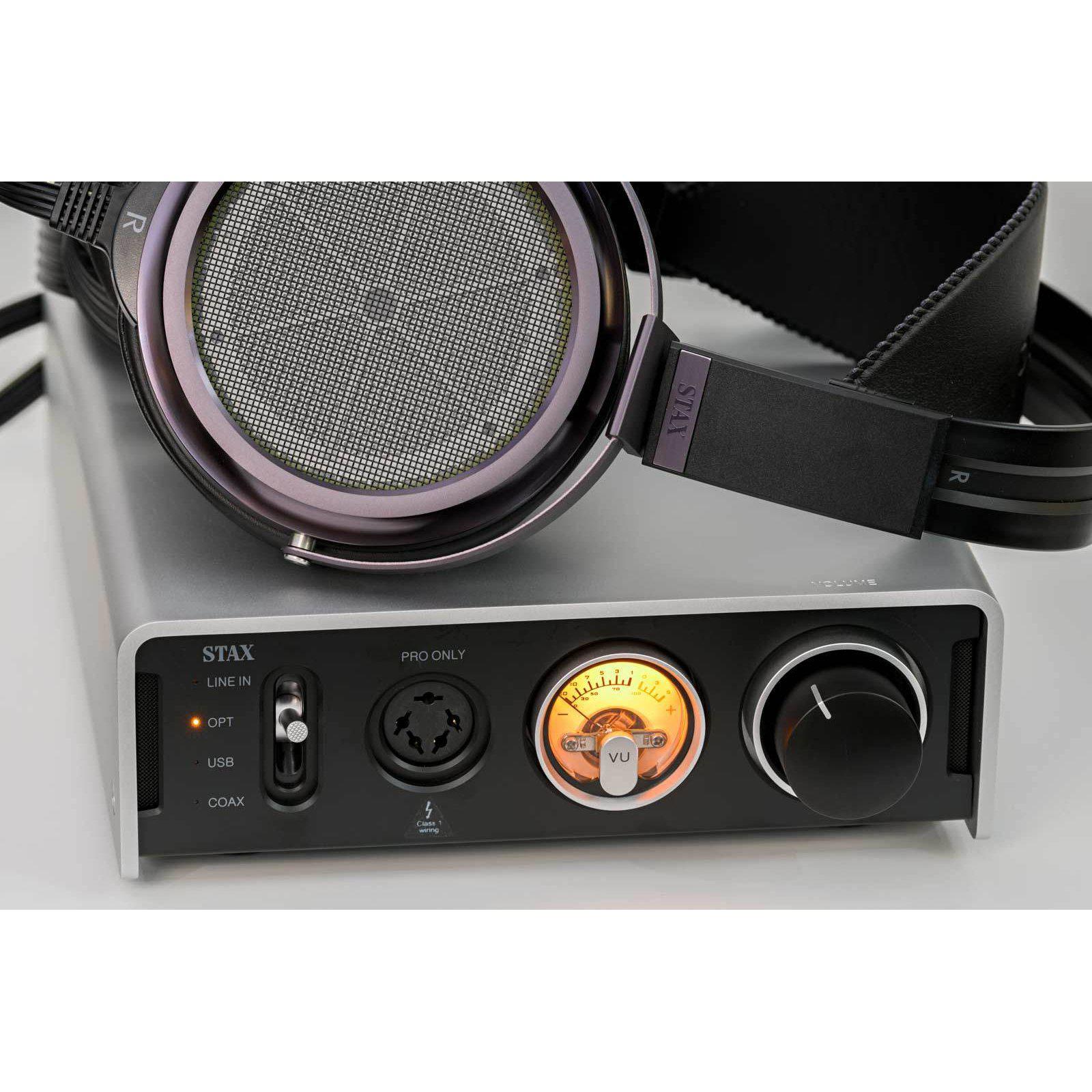 STAX SRM-D50 Electrostatic Headphone Amplifier DAC with glowing VU meter and cable-connected headphones on top