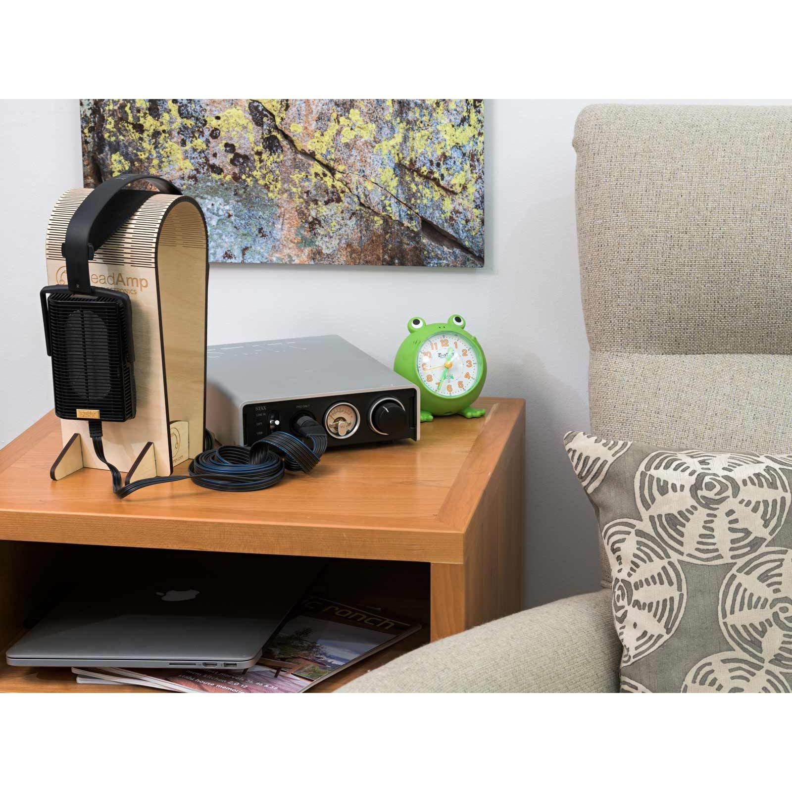 STAX SRM-D50 Electrostatic Headphone Amplifier / DAC on wooden table next to headphones and green frog alarm clock