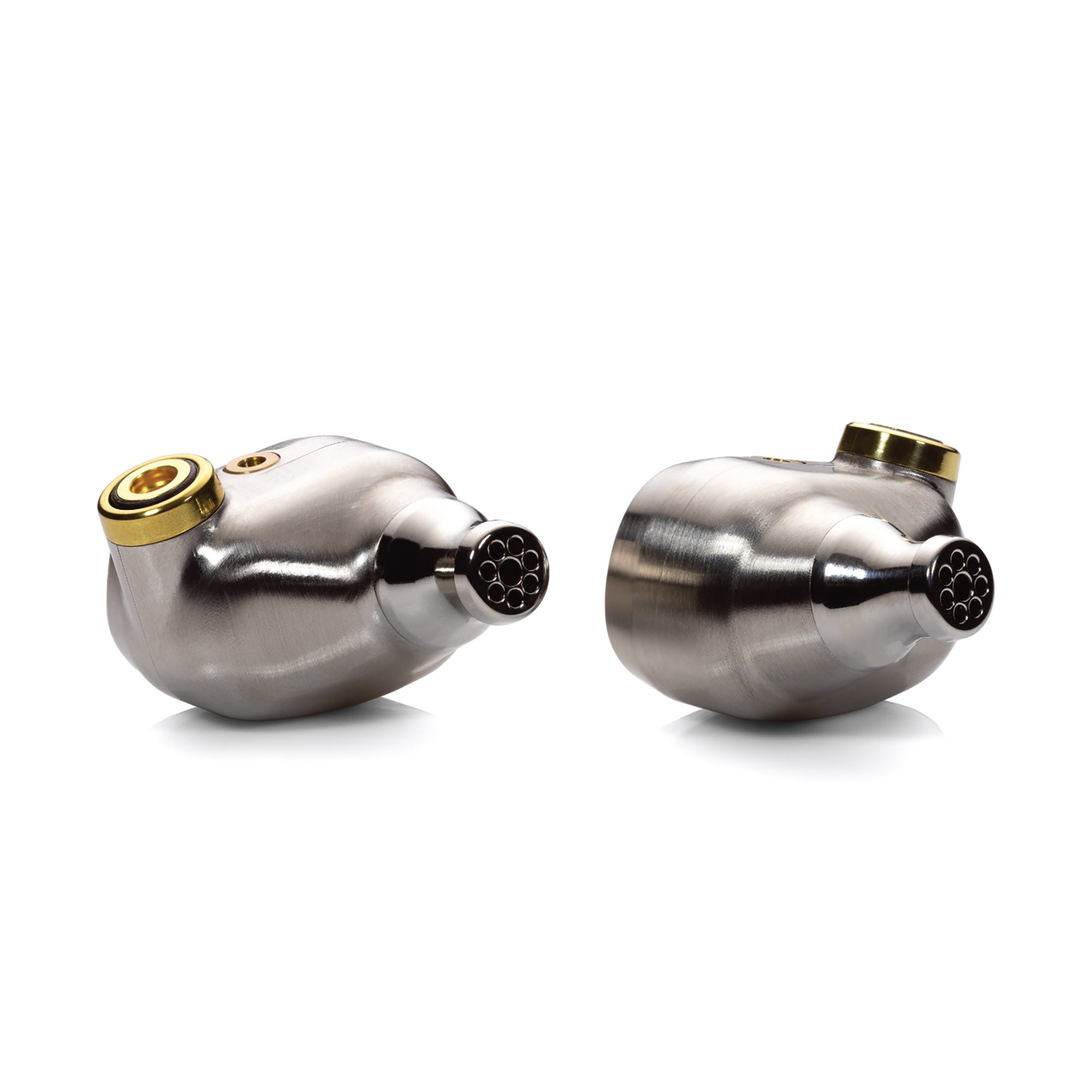 Close-up of Campfire Solaris 'Stellar Horizon' in-ear monitors with silver housing and gold connector on white background