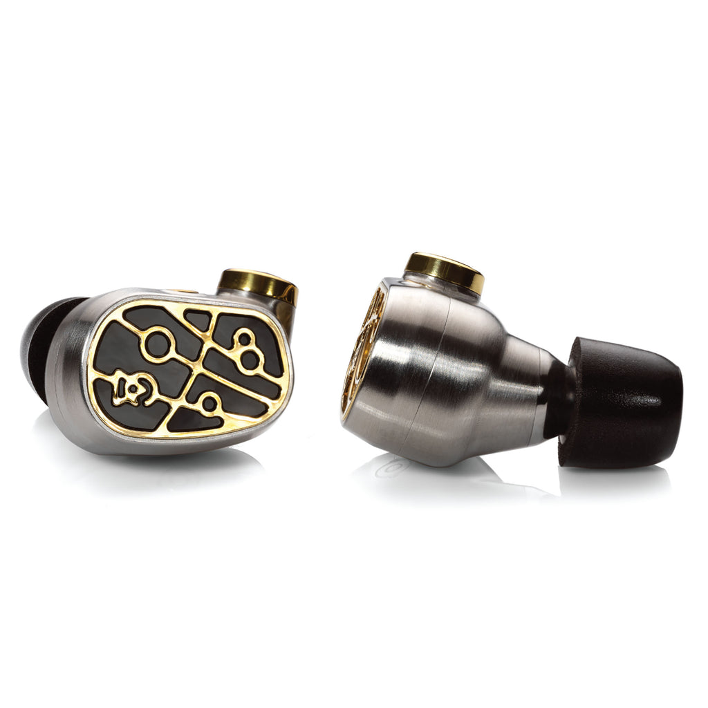 Close-up of Campfire Solaris 'Stellar Horizon' in ear monitors showing metallic body and intricate gold design on white background