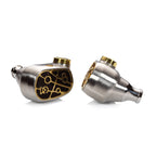 Close-up of Campfire Solaris 'Stellar Horizon' in ear monitors with silver finish and gold accents on white background