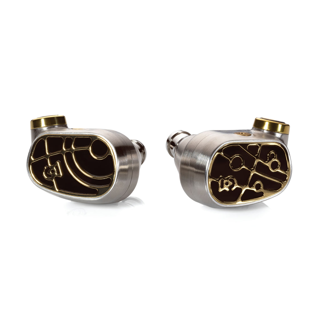 Close-up of Campfire Solaris 'Stellar Horizon' in-ear monitors with intricate gold and silver design on white background