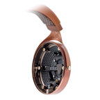 Close-up of the Focal Stellia Closed-Back Dynamic Headphones showing the internal driver and copper-colored ear cup detail