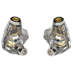 Close-up of transparent Campfire Trifecta - Flagship IEM showing gold internal components and connector pins on white background