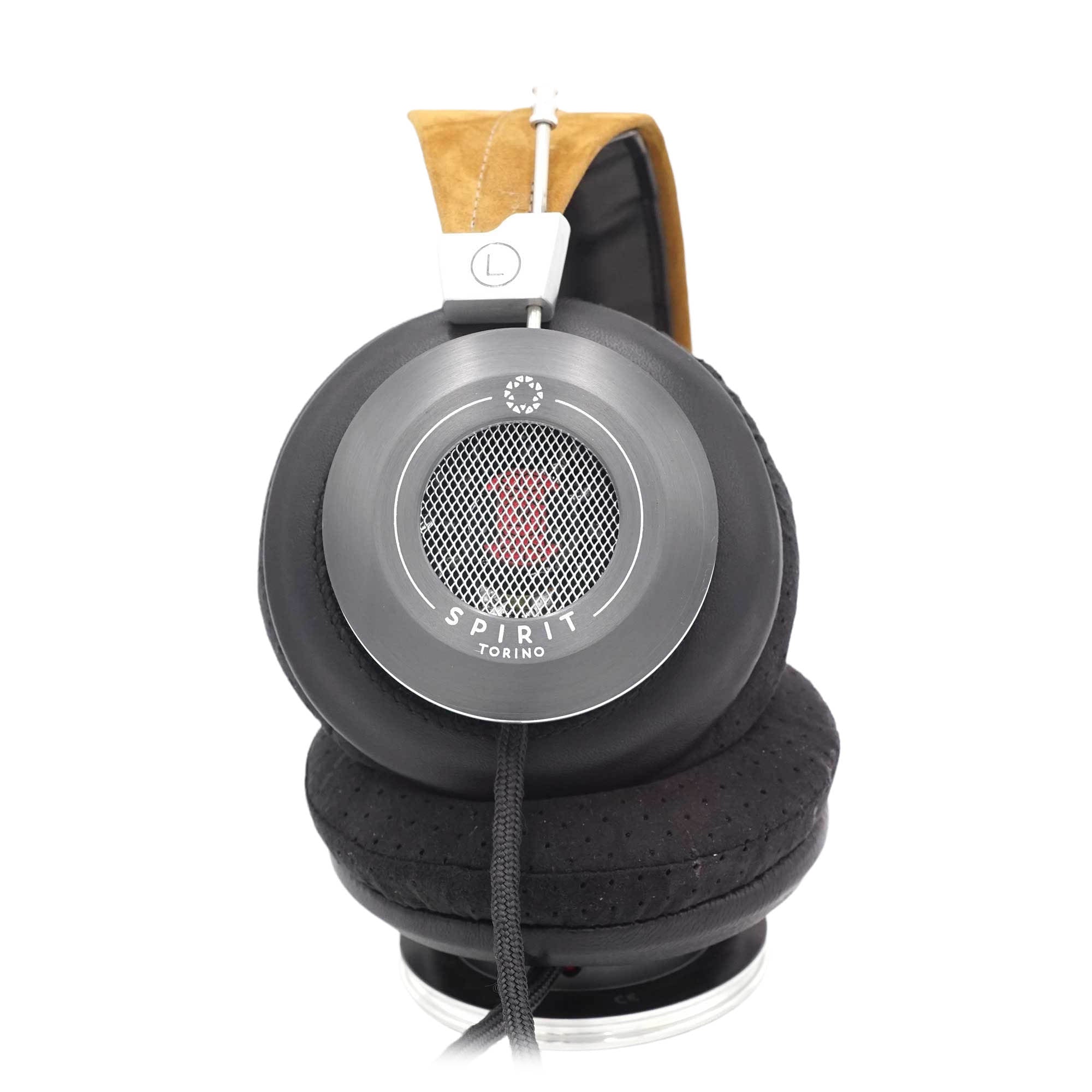 Close-up of Spirit Torino Twin Pulse dynamic open back headphones with black ear cups and tan suede headband on white background