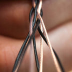 Close-up of intertwined copper and black wires showcasing Kimber Kable Axios Copper Headphone Cable craftsmanship detail