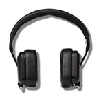 Top view of Campfire Cascade closed back headphones with black leather ear pads and metal headband on white background