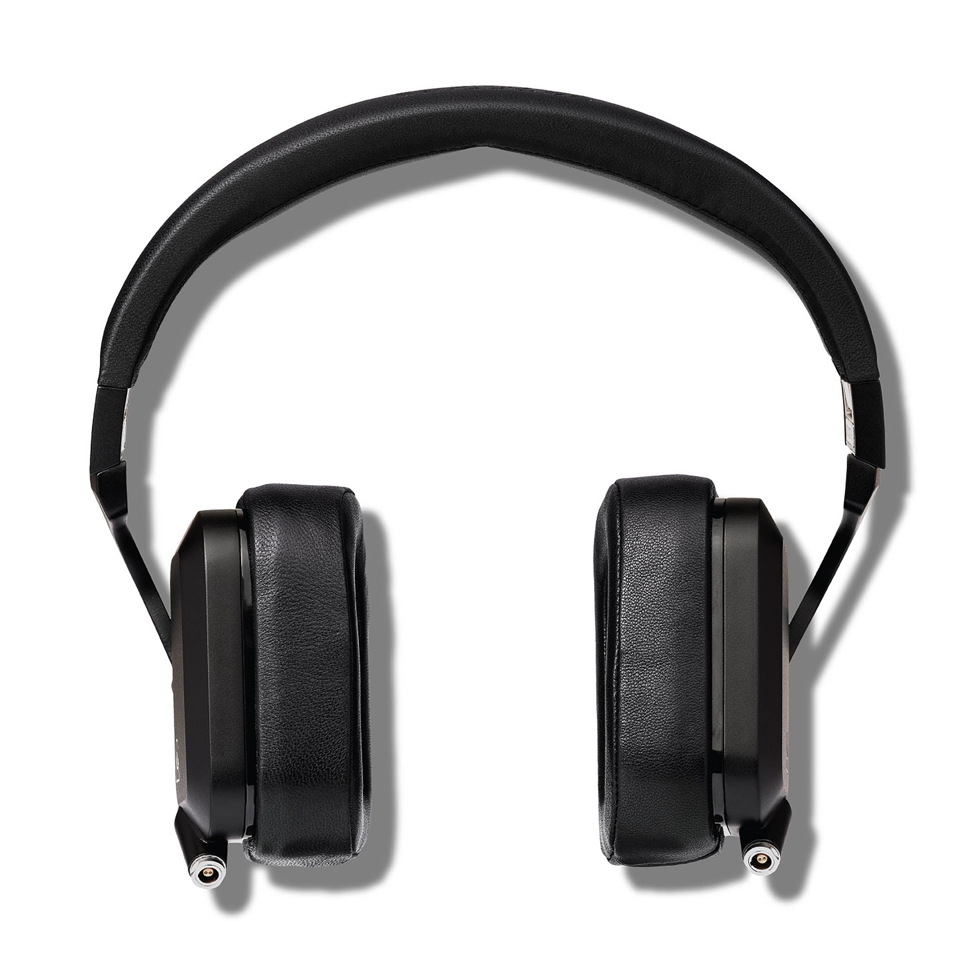 Top view of Campfire Cascade closed back headphones with black leather ear pads and metal headband on white background