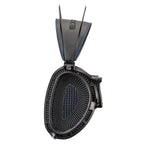 Close-up of Dan Clark Audio Expanse open-back ear cup showing black mesh driver and headband with blue stitching