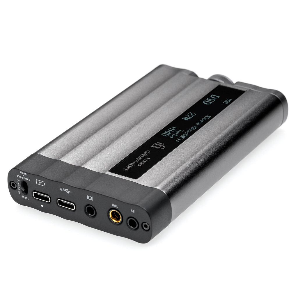 iFi Audio xDSD Gryphon Portable DAC/Amp showing digital display and multiple audio input and output ports on gray surface