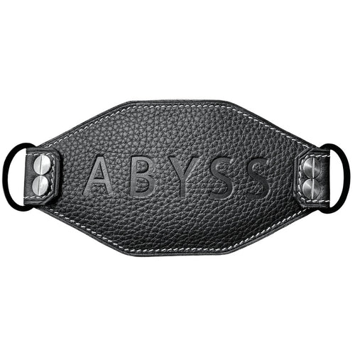 Close-up of black Abyss AB-1266 Leather Headband showing textured leather and embossed ABYSS logo with metal attachments