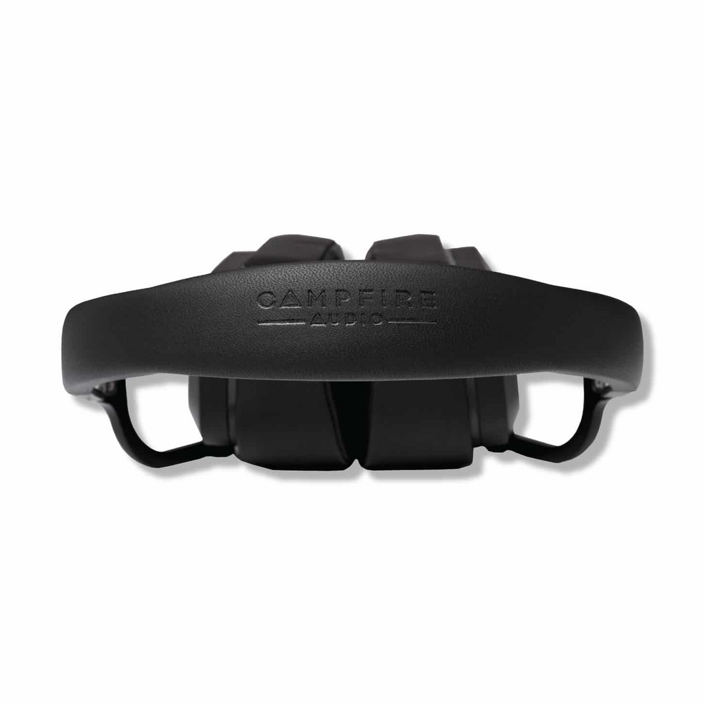 Top view of black Campfire Cascade closed back headphones with padded headband and embossed logo on white background