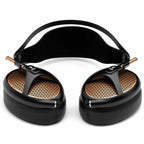 Meze Empyrean open-back headphones with black frame and distinctive copper grille pattern on white background
