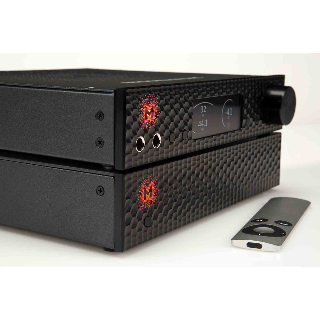 Mytek Brooklyn AMP+ stereo amplifier with textured front panel, digital display, headphone jacks, and remote control on white background